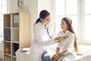 Female doctor examining a girl. 